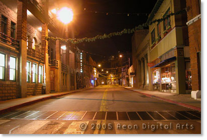 Photo of the main street in Bisbee at night with shops on both sides of the street.