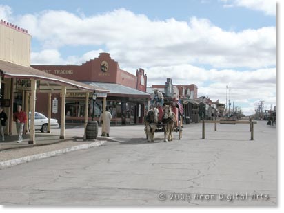 Photo of the historic town of Tombstone with a horse drawn carriage coming down the street.